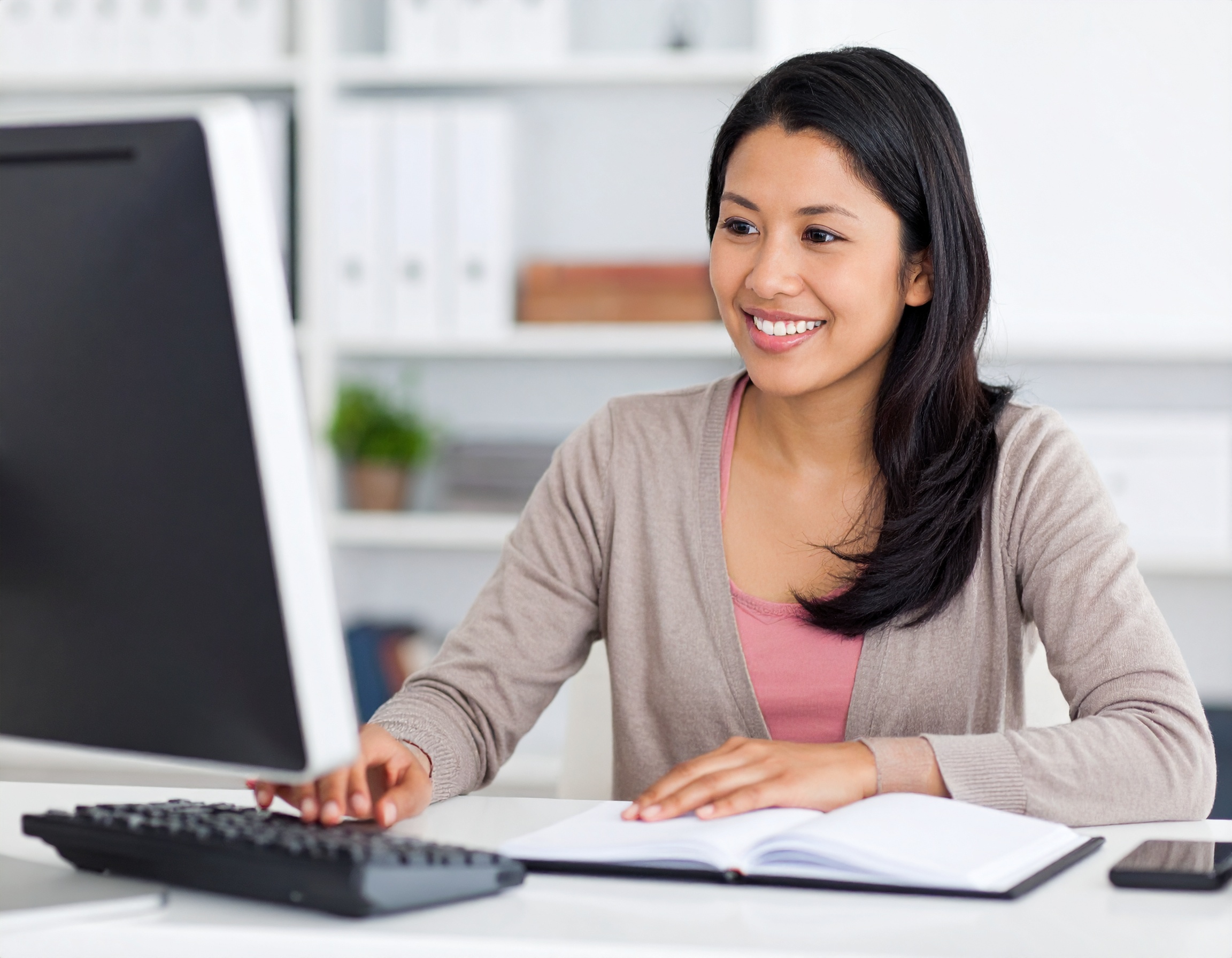 Construction Bookkeeper working at computer